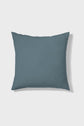 A square, solid slate-blue throw pillow is shown against a plain white background.