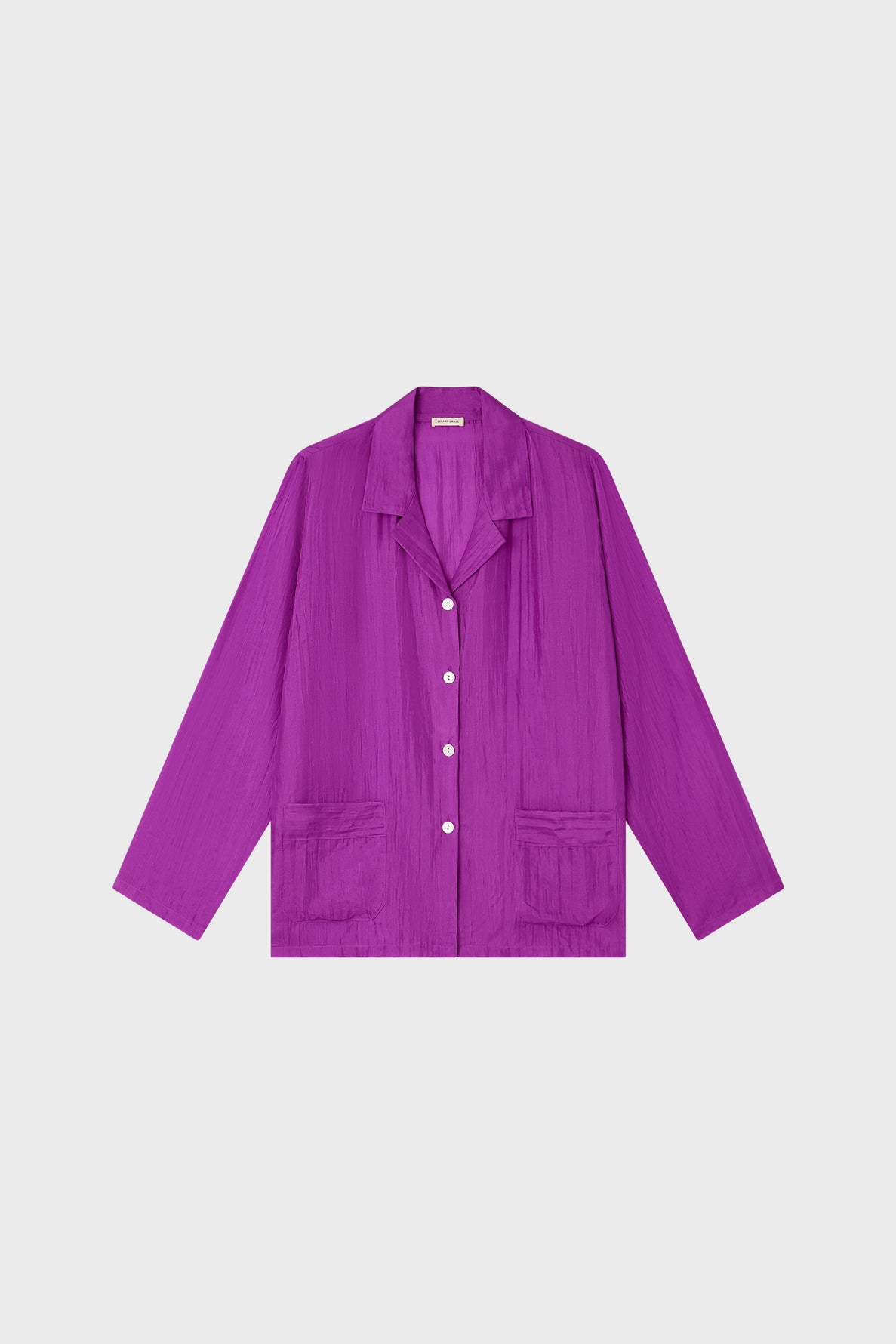 A long-sleeve, button-up shirt in bright purple with a notched collar and two front pockets, displayed on a plain white background—perfect as the top for a pyjama deux pièces or for adding a touch of elegance to your pyjama violet ensemble.