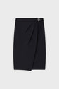 Black knee-length wrap skirt with a front pleat, a subtle overlap, and a small silver buckle detail on the waistband, displayed on a plain light background.