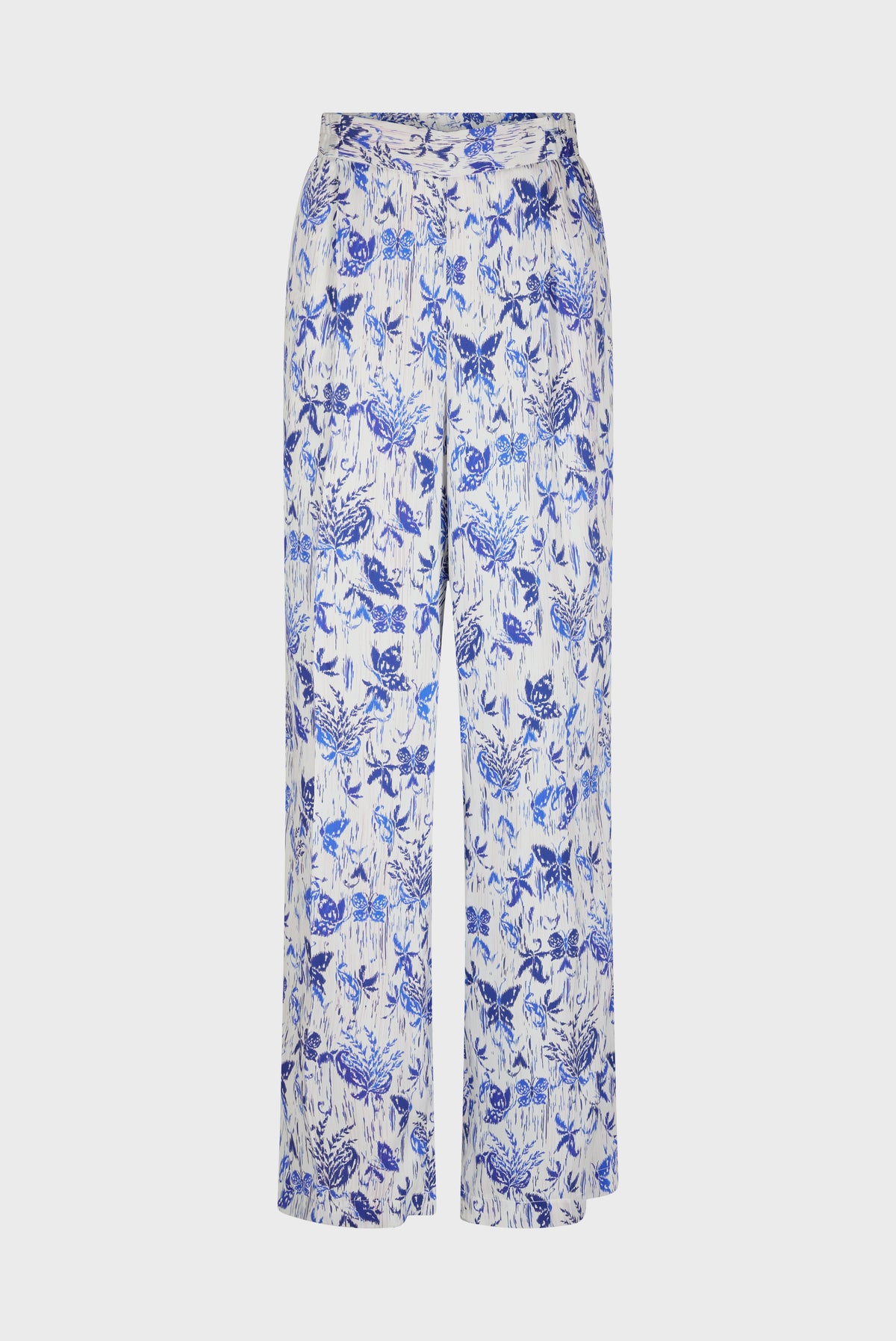 White, high-waisted pantalon large featuring an all-over blue imprimé fleuri and nature-inspired print, displayed on a plain background.