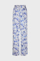 White, high-waisted pantalon large featuring an all-over blue imprimé fleuri and nature-inspired print, displayed on a plain background.