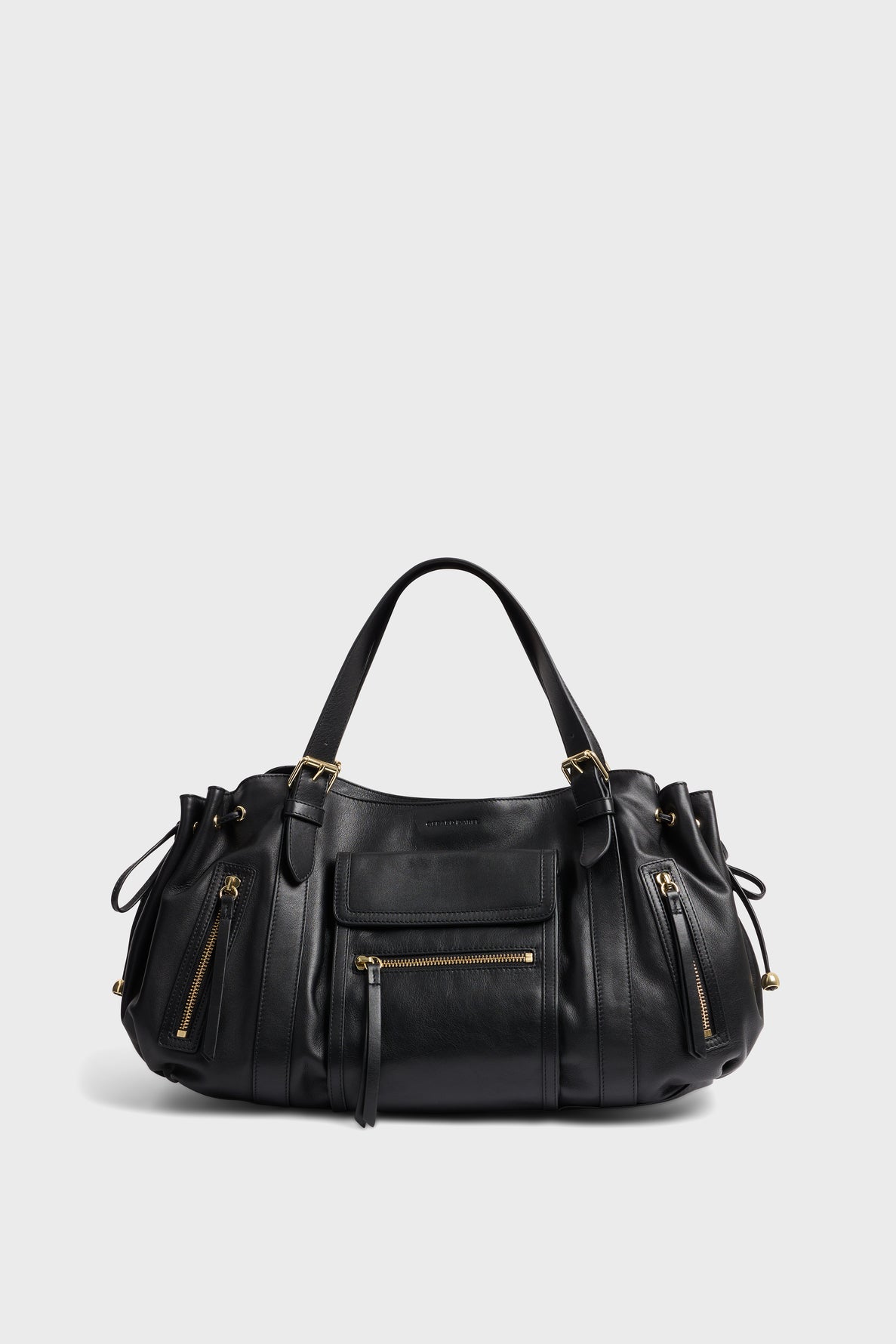 A black sac à main crafted from cuir délicat with gold zippers and hardware, featuring two handles, multiple exterior poches zippées, and side drawstring details, set against a plain light gray background.