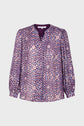 Purple long-sleeve blouse with a patterned design of pink, white, and lavender spots, a v-neckline, and buttoned cuffs, displayed on a plain white background.