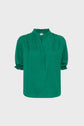 A green, short-sleeve blouse with a subtle textured pattern, ruffled collar, and ruffled sleeve hems, displayed on a plain white background.