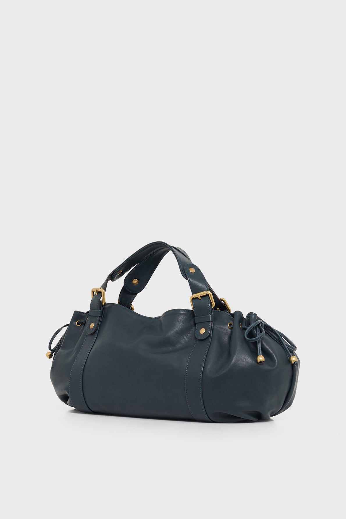 A dark blue sac à main crafted from cuir délicat with gold hardware, two handles, and drawstring details on each end, this elegant piece of maroquinerie Darel is set against a plain white background.