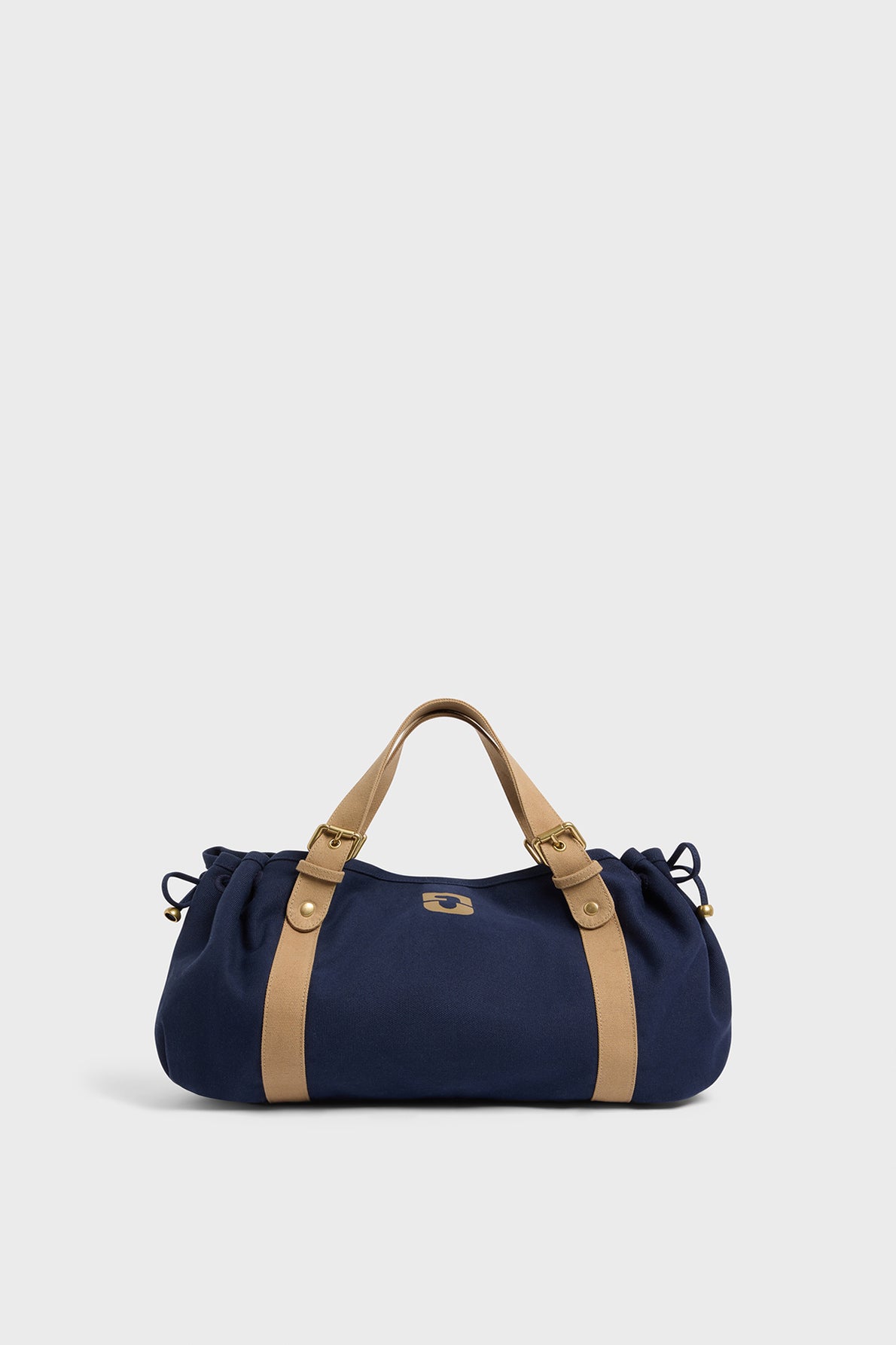 A navy blue GD Canvas duffel bag with tan leather handles and straps, displayed against a plain light gray background.