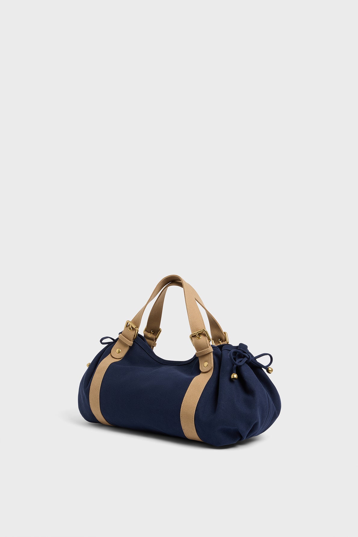 A navy blue GD Canvas duffel-style sac à main toile with tan straps and gold accents, displayed against a plain white background.