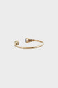 A gold open cuff bracelet with two decorative ends, one featuring a green stone and the other a gray stone, displayed on a plain white background.